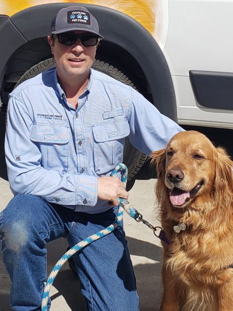 Owner Dale Huskey with his dog in front of a company truck